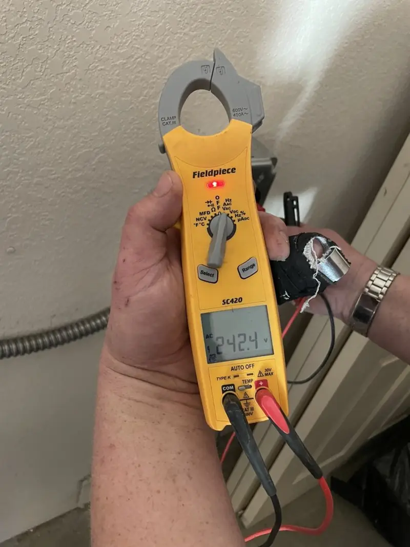 Voltage testing with clamp meter during Recessed Lighting Installation in Enumclaw